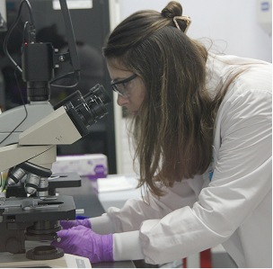 Scientist using a microscope in a laboratory