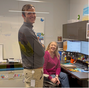 Two colleagues smiling together in an office